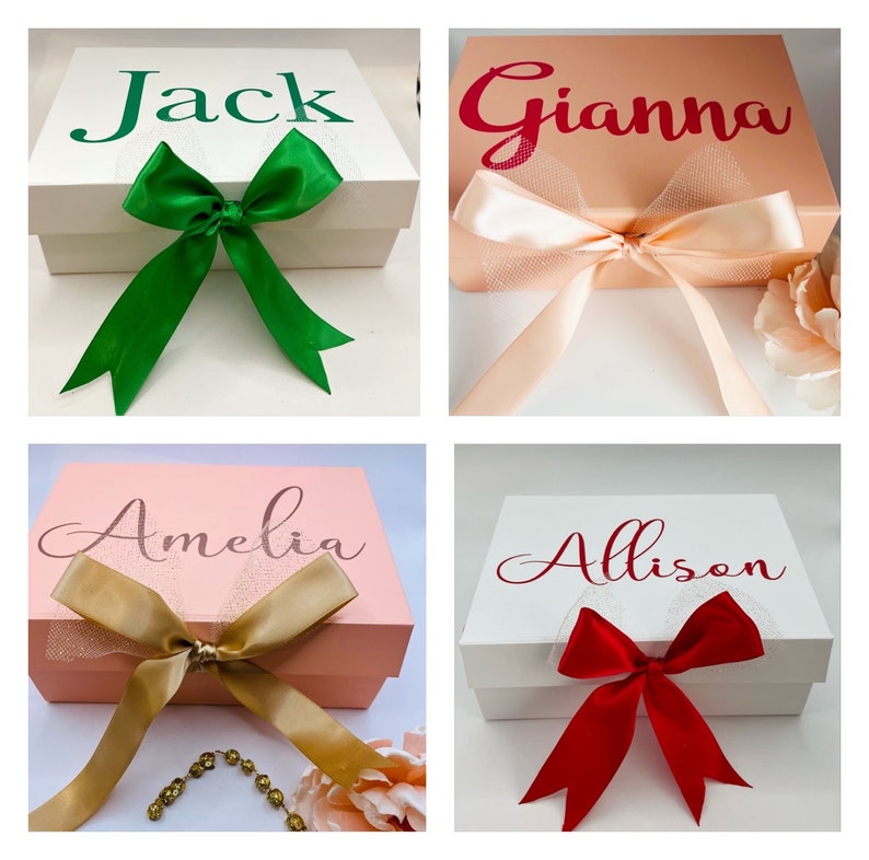 May include: Four white gift boxes with different colored ribbons and bows. The boxes are personalized with the names Jack, Gianna, Amelia, and Allison.