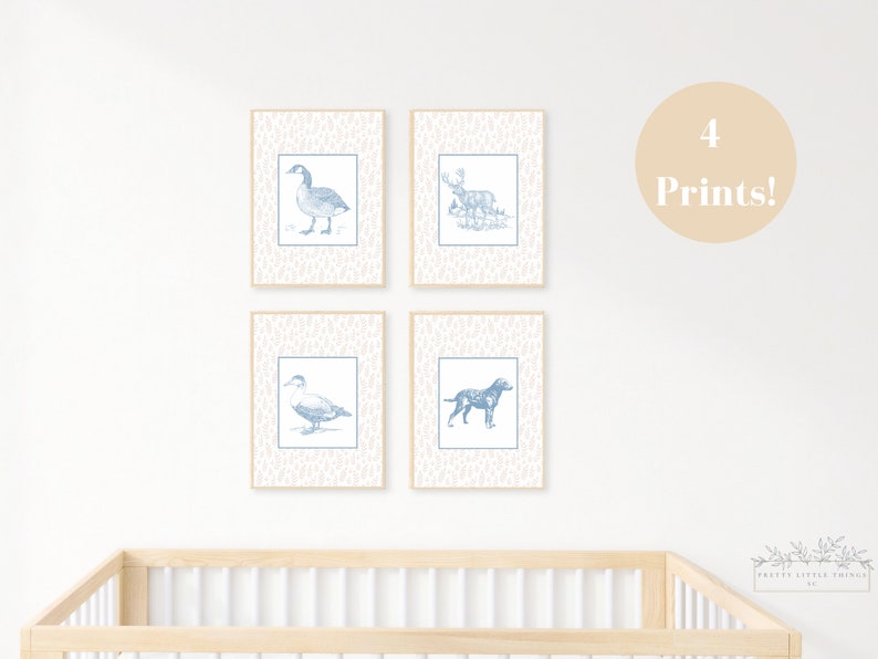 May include: Four blue and white prints of animals, including a goose, a deer, a duck, and a dog. The prints are framed and displayed on a white wall above a wooden crib.