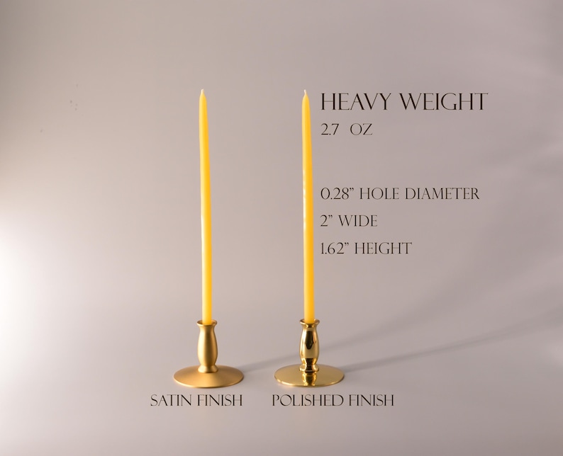 May include: Two gold metal candle holders with yellow taper candles. One has a satin finish and the other a polished finish. Text reads: HEAVY WEIGHT, 2.7 OZ, 0.28" HOLE DIAMETER, 2" WIDE, 1.62" HEIGHT, SATIN FINISH, POLISHED FINISH.