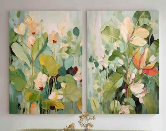 May include: Two abstract floral paintings with green, yellow, and peach tones hang above a green velvet sofa. The paintings feature large leaves and flowers. A glass coffee table and two vases are in front of the sofa. The text "Artis More" is visible.