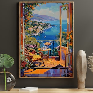 May include: A painting depicting a balcony overlooking a blue ocean with a view of a town on the hillside. The balcony features a wicker chair, a small table with a teacup and saucer, and a potted plant. The painting is framed in a brown wood frame.