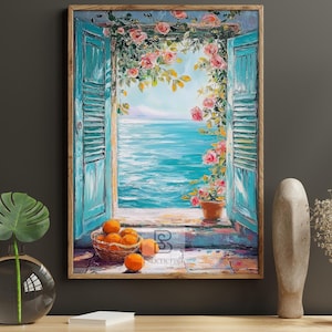 May include: A framed painting shows a coastal scene with turquoise shutters framing a view of the sea. Pink roses cascade over the window. A basket of oranges sits on the windowsill. The artwork is in a wooden frame.