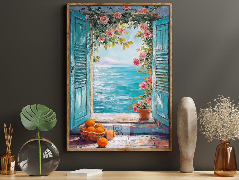 May include: A framed painting shows a coastal scene with turquoise shutters framing a view of the sea. Pink roses cascade over the window. A basket of oranges sits on the windowsill. The artwork is in a wooden frame.