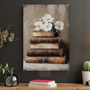 May include: An oil painting depicts a stack of antique books topped with white flowers. The books are various sizes and shades of brown, with visible titles. The artwork is displayed on a dark wall, with decorative elements like vases and a cactus.