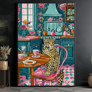 May include: A leopard sits on a pink chair in a kitchen with floral wallpaper. The leopard is looking to the left. There is a table with a teacup and saucer on it.