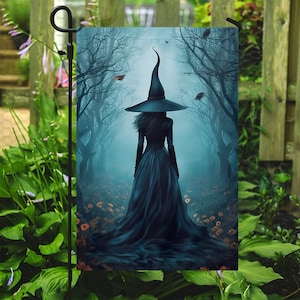 May include: A witch in a black dress and pointed hat walks through a misty forest. The forest is filled with bare trees and a soft blue light.