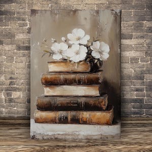 May include: An oil painting depicts a stack of old books with white flowers in a vase on top. The books are brown and beige, with visible text on the spines. The background is a neutral color, and the painting is set against a brick wall.