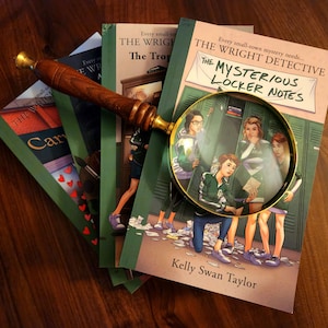 May include: A stack of mystery novels with green and tan covers, featuring the title "The Wright Detective" and "The Mysterious Locker Notes." A magnifying glass with a wooden handle rests on the books, enhancing the detective theme.