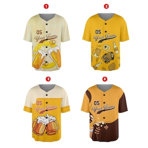 Pode incluir: Quatro camisas de beisebol amarelas com detalhes marrons. Cada camisa tem um design diferente com canecas de cerveja, pretzels e instrumentos musicais. O texto "05 Your Team" está impresso em cada camisa.