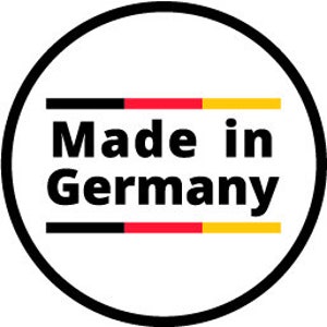 May include: A black and white circle with the text "Made in Germany" in black letters. The circle has a red and yellow stripe at the top and bottom.