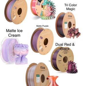 May include: Assortment of spools of filament for 3D printing in various colors, including pastel rainbow, tri color sky, matte ice cream, matte purple, tri color magic, dual red and black, and tri color copper.