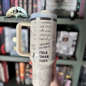 May include: White travel mug with a silver design featuring a shark and the text "You're a goddamn siren and I'm the fool who would gladly drown just to get a taste of you. You're so much more than the people who have hurt you. Vitale Shark Tours. Show me I know who's got your back."