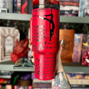 May include: A white ceramic mug with a black handle and the text "But First, Coffee" in a bold, black font. The mug is sitting on a wooden surface. The mug is 4 inches tall.