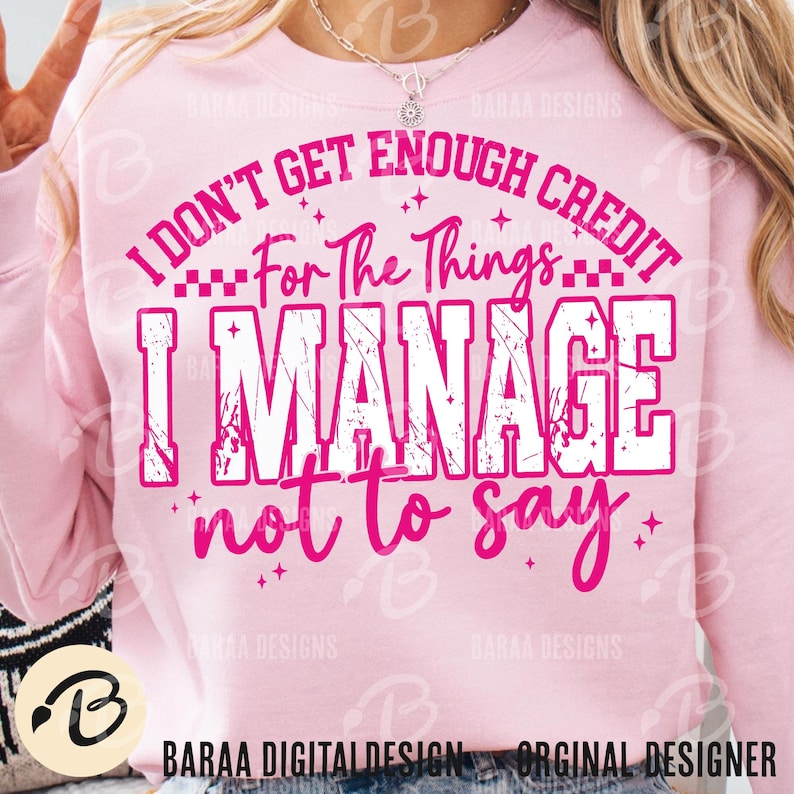 May include: A light pink sweatshirt with the text "I DON'T GET ENOUGH CREDIT For The Things I MANAGE not to say" in white and pink. The sweatshirt has long sleeves and a crew neck. The design includes stars and the words "BARAA DESIGNS".