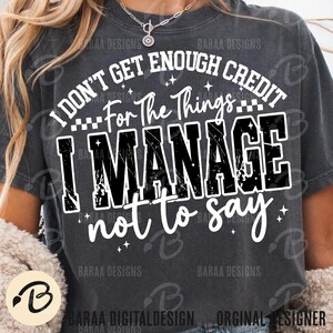 May include: Dark gray t-shirt with the text "I DON'T GET ENOUGH CREDIT For The Things I MANAGE not to say" in white and black. The shirt has a distressed, vintage look, with the words in a bold, readable font.