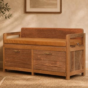 May include: A wooden storage bench featuring a natural brown finish, a rectangular backrest, and two front-facing drawers with horizontal slats and small metal handles. A tan-colored rectangular cushion sits on the seat of the bench.