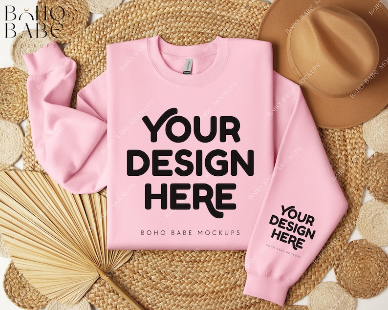 May include: A pink sweatshirt mockup with the text "Your Design Here" and "BOHO BABE MOCKUPS" on a natural woven background with a straw hat and a fan.