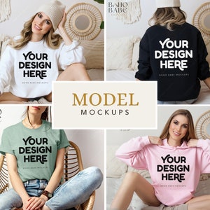 May include: A collection of four apparel mockups featuring a white sweatshirt, a black sweatshirt, a sage green t-shirt, and a light pink hoodie. Each garment displays the bold black text "YOUR DESIGN HERE" centered on the front or back.