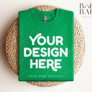 May include: A green t-shirt mockup with the text "YOUR DESIGN HERE" on a woven wicker surface. The text "BOHO BABE MOCKUPS" is printed on the bottom of the shirt.