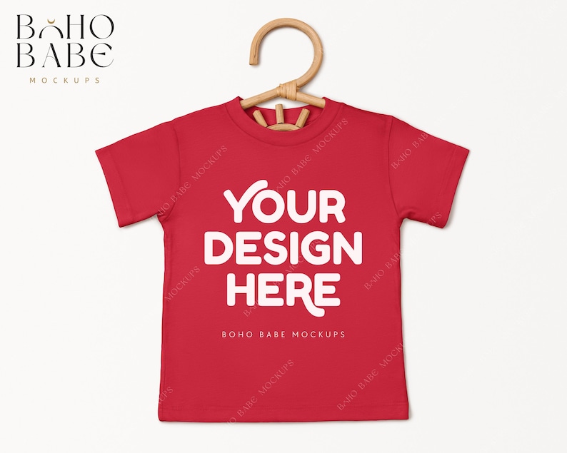 May include: Red short-sleeved t-shirt with the text "YOUR DESIGN HERE" and "BOHO BABE MOCKUPS" printed on the front.