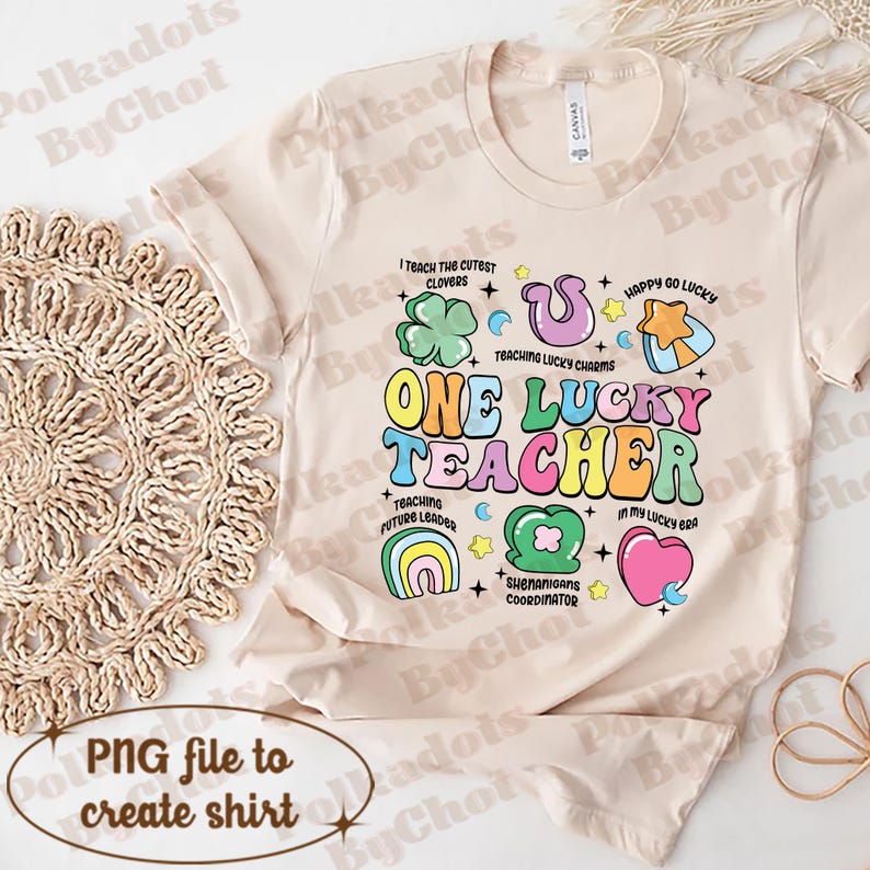 May include: A beige t-shirt featuring a colourful graphic design that reads "One Lucky Teacher". The graphic includes shamrocks, rainbows, stars, and hearts. The text "I teach the cutest clovers", "Teaching lucky charms", "Teaching future leaders", "Shenanigans coordinator", "Happy go lucky", and "In my lucky bra" are also included in the design.