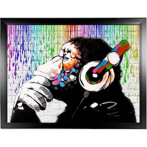 May include: A black and white illustration of a monkey wearing headphones with colorful paint splatters on its face. The background is a white brick wall with colorful paint drips.