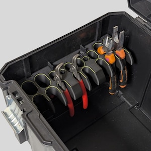 May include: A black toolbox with a variety of pliers and tools organised in a holder. The holder has multiple slots for different sized tools. The tools are red, orange, and black.