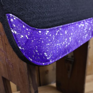 May include: Purple saddle pad with a silver and white speckled trim. The pad is made of a soft, plush material and is designed to provide comfort and support for your horse.