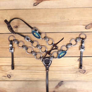 Ring Headstall tack set engraved with Two tone flower conchos with matching buckle.One ear Headstall and breast collar tack (RING TACK)