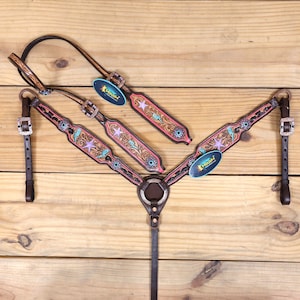 Western headstall and breast collar tack set has leopard, star, and thunder carvings with antique finish rhinestone and berry stone conches