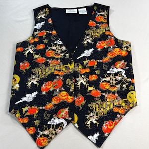 May include: A black Halloween vest with a repeating pattern of orange pumpkins, witches, ghosts, and haunted houses. The vest has a V-neck and button closure. The vest is a festive garment for the spooky season.