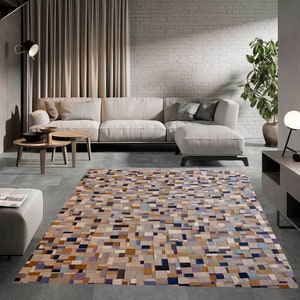 May include: A modern living room with a white sectional sofa, a patterned rug, and a side table with a lamp. The room has a white brick wall and a large window.