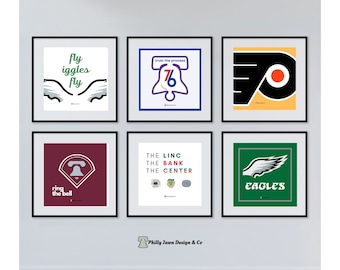 May include: Six framed prints with different designs related to Philadelphia sports teams. The top row features a print with the words "fly eagles fly" and a pair of wings, a print with the Liberty Bell and the words "trust the process", and a print with the Philadelphia Flyers logo. The bottom row features a print with the Liberty Bell and the words "ring the bell", a print with the words "the linc, the bank, the center", and a print with the Philadelphia Eagles logo and the word "eagles".