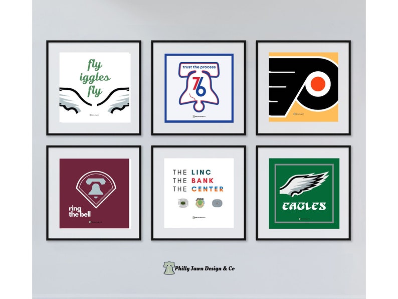May include: Six framed prints featuring different designs related to Philadelphia sports teams. The top row includes a print with the words "fly eagles fly" and a pair of wings, a print with the Liberty Bell and the words "trust the process", and a print with the Philadelphia Flyers logo. The bottom row includes a print with the Liberty Bell and the words "ring the bell", a print with the words "the linc, the bank, the center", and a print with the Philadelphia Eagles logo and the word "eagles".