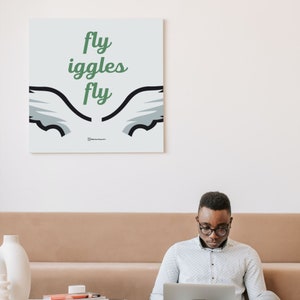 May include: A white canvas print with a green and black graphic of wings and the text "fly giggles fly".