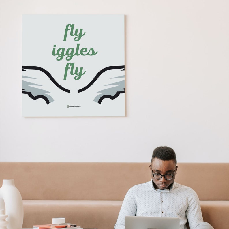 May include: A white canvas print with a green and black graphic of wings and the text "fly giggles fly".