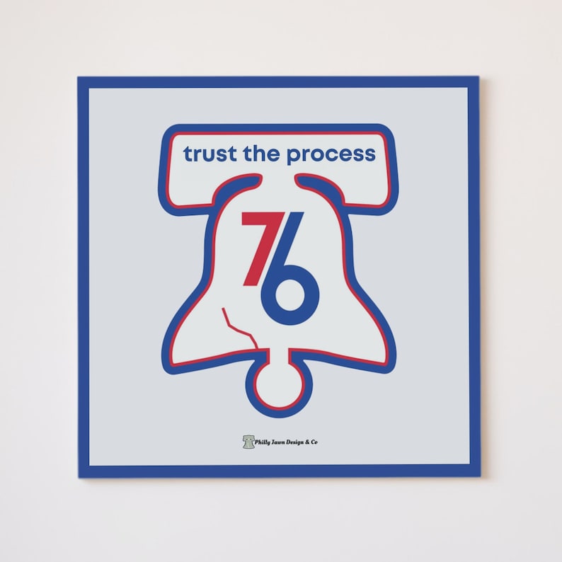 May include: A blue and red graphic of the Liberty Bell with the number 76 inside. The text "trust the process" is above the bell. The text "Philly Town Design & Co." is below the bell.