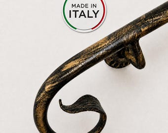 May include: A curved metal handrail with a distressed black and gold finish, featuring a decorative scroll end and a mounting bracket. A circular white sticker with a green, white, and red border displays the text MADE IN ITALY in black.