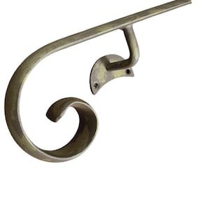 May include: A metal handrail with a decorative scroll design. The handrail is made of a dark metal with a slightly aged finish.