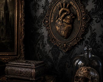 May include: An oval wall plaque featuring a sculpted anatomical heart in a bronze finish, surrounded by an ornate frame with the text Where roses wilt my love remains. The plaque is displayed alongside a skull under a glass dome and books.