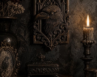 May include: A rectangular wall plaque featuring a relief sculpture of a raven head set within an ornate, dark bronze-toned gothic frame with intricate scrollwork details and pointed arches at the top and bottom edges of the decorative piece.