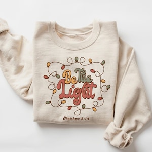 Be The Light Sweatshirt, Religious Christmas Sweatshirt, Christian Holiday Sweater, Faith Jesus Gift, Christmas Gifted, Bible Verse Crewneck
