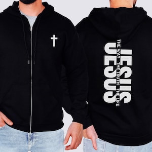 May include: Black zippered hoodie with a white cross on the front and the words "JESUS THE WAY THE TRUTH THE LIFE" vertically down the back.