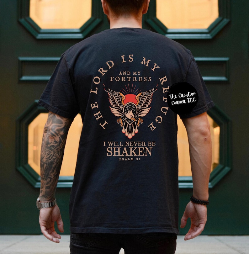 May include: Black t-shirt with a graphic of an eagle with the text "The Lord is my refuge and my fortress. I will never be shaken. Psalm 91."