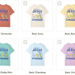May include: A collection of ten short-sleeve t-shirts in various colors including white, terracotta, ivory, banana, butter, bay, chalky mint, chambray, orchid, and blossom. Each shirt features a graphic print with the text 'Just my JESUS and some LEMONADE'.