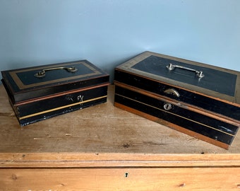 Extra and Extra extra Large vintage black and gold metal money boxes both including keys and removable internal coin compartments