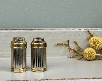 Miniature pair of gold and silver metal salt and pepper shakers