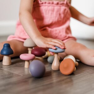 Child enjoying imaginative play with Montessori mushroom toy set
