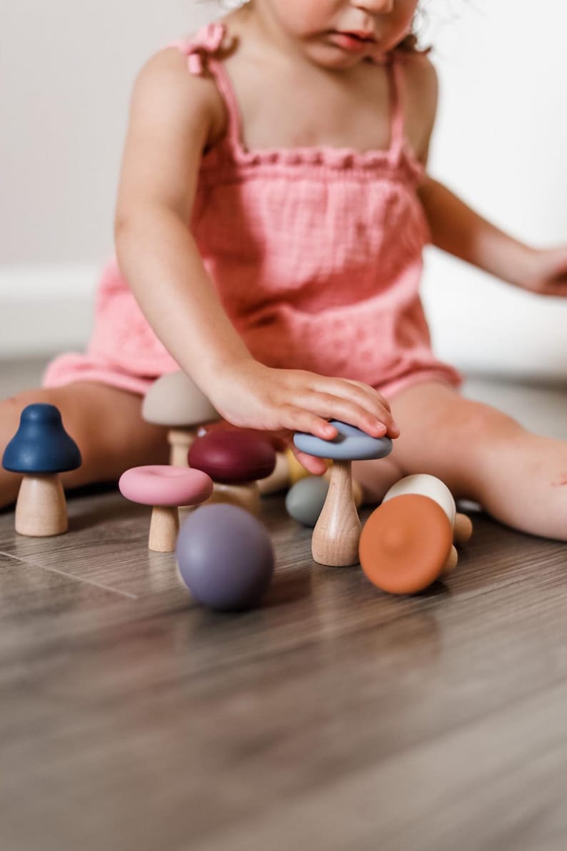 Child enjoying imaginative play with Montessori mushroom toy set