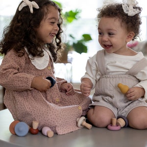 Child stacking and matching Montessori mushroom toy pieces